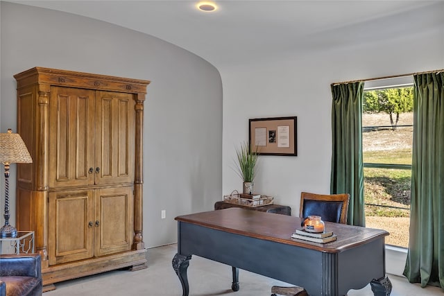 carpeted office with vaulted ceiling