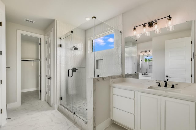 bathroom with walk in shower and vanity