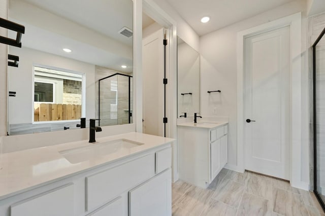 bathroom with walk in shower and vanity