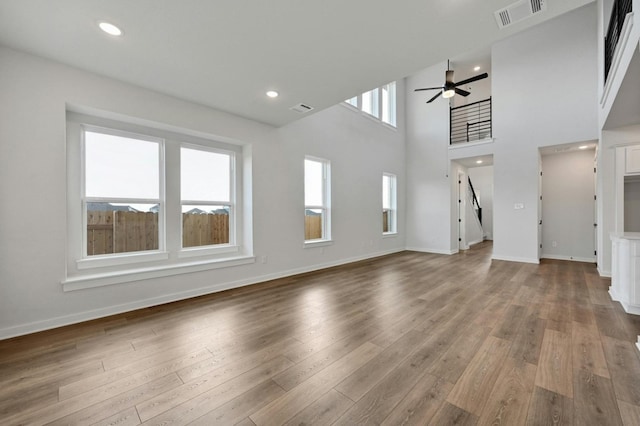 unfurnished living room featuring hardwood / wood-style floors and ceiling fan