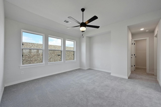 carpeted spare room with ceiling fan