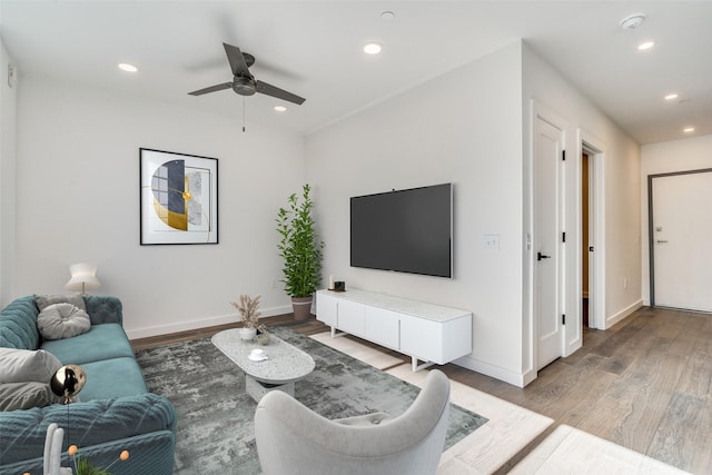 living room featuring ceiling fan and hardwood / wood-style flooring