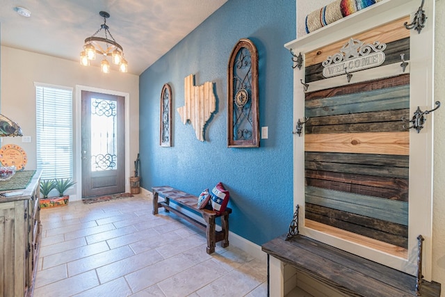 tiled entryway with an inviting chandelier