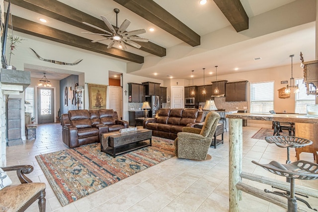 tiled living room with beam ceiling and ceiling fan with notable chandelier