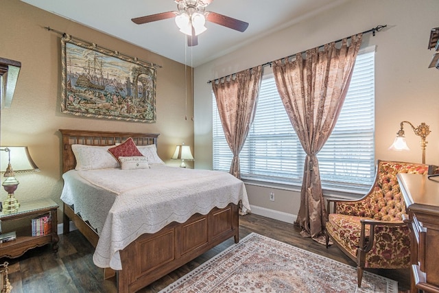 bedroom with dark hardwood / wood-style flooring and ceiling fan