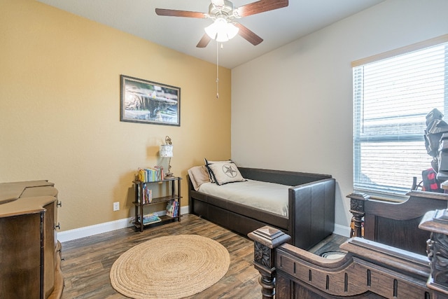 living area with ceiling fan and dark wood-type flooring