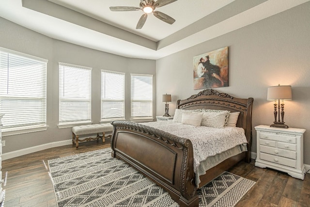 bedroom with multiple windows, dark hardwood / wood-style floors, and ceiling fan