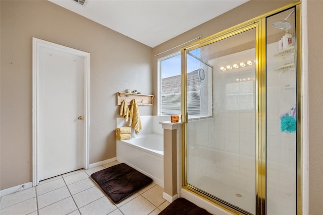 bathroom with tile patterned flooring and separate shower and tub