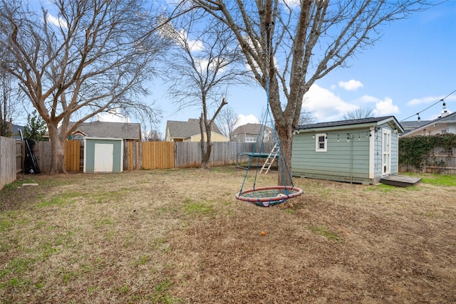 view of yard with a shed and a trampoline