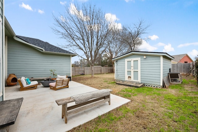 view of patio / terrace featuring a shed and a fire pit