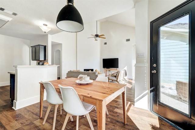 dining space featuring ceiling fan and dark wood-type flooring