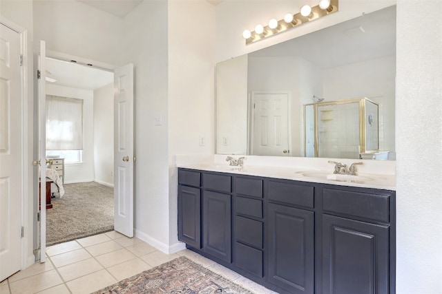 bathroom with tile patterned flooring, vanity, and a shower with shower door