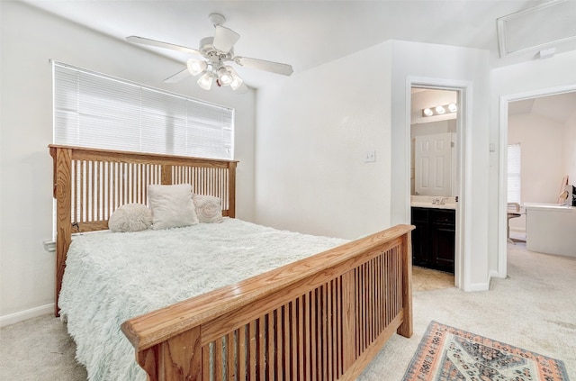 carpeted bedroom with ensuite bathroom and ceiling fan