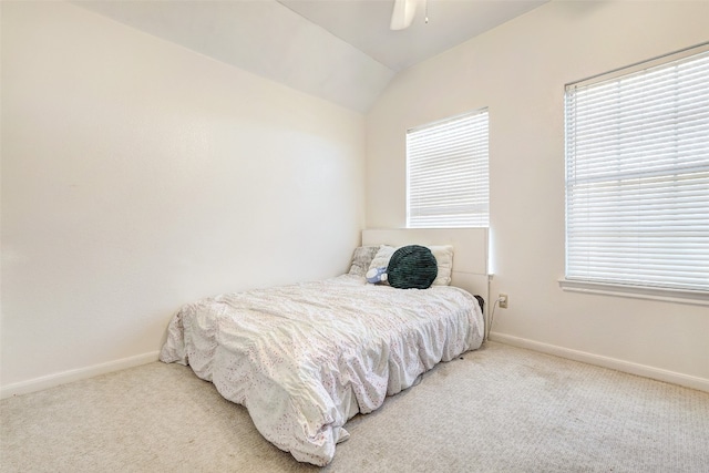 carpeted bedroom with ceiling fan and vaulted ceiling