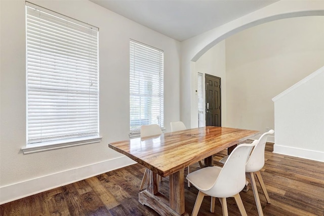 dining space with dark hardwood / wood-style flooring