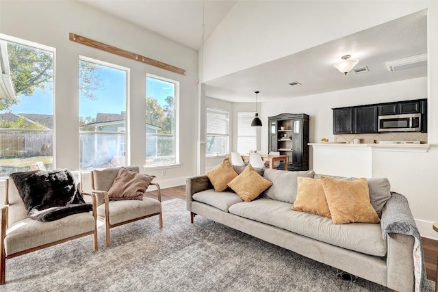 living room featuring hardwood / wood-style flooring and lofted ceiling