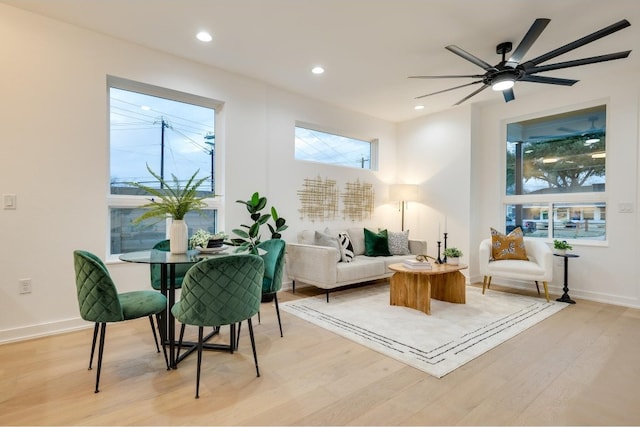 sitting room featuring light hardwood / wood-style floors, ceiling fan, and a wealth of natural light