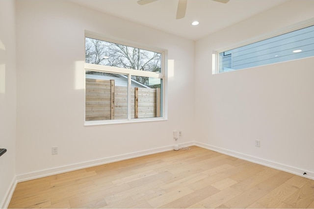 unfurnished room featuring ceiling fan, light hardwood / wood-style flooring, and a wealth of natural light