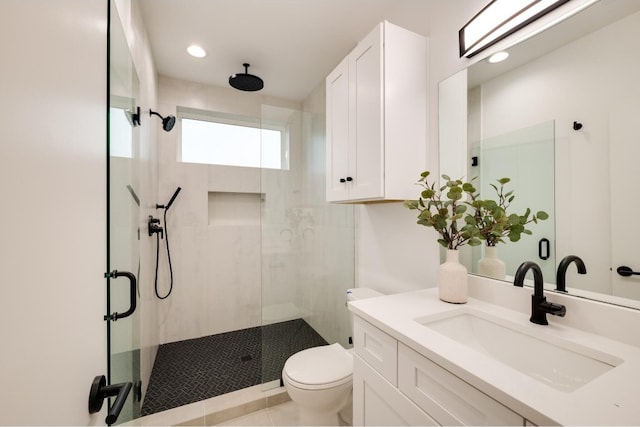 bathroom with vanity, a shower with shower door, and toilet