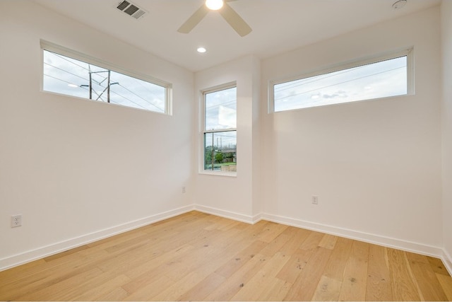 spare room with light hardwood / wood-style floors and ceiling fan