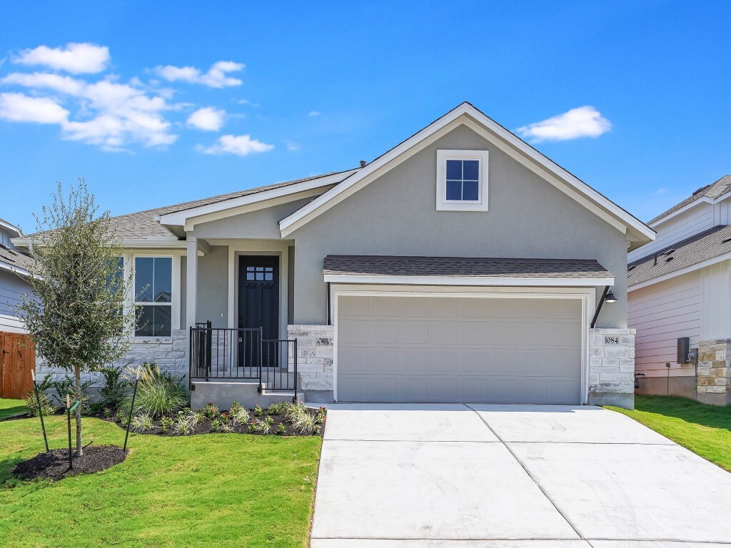 view of front of home with a front lawn and a garage