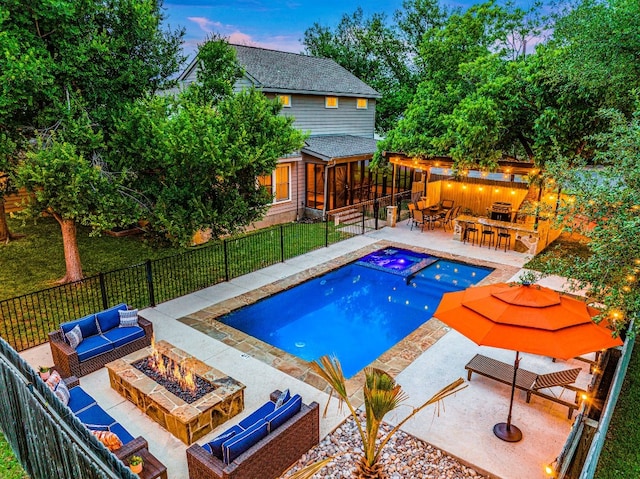 pool at dusk featuring a patio, a bar, an in ground hot tub, and an outdoor living space with a fire pit