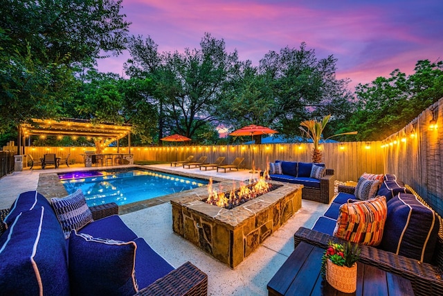 pool at dusk with a patio and an outdoor hangout area