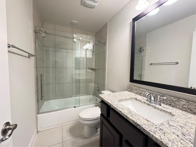 full bathroom featuring tile patterned flooring, a textured ceiling, combined bath / shower with glass door, toilet, and vanity