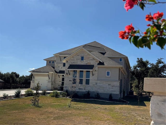 view of front facade featuring a front yard and a garage