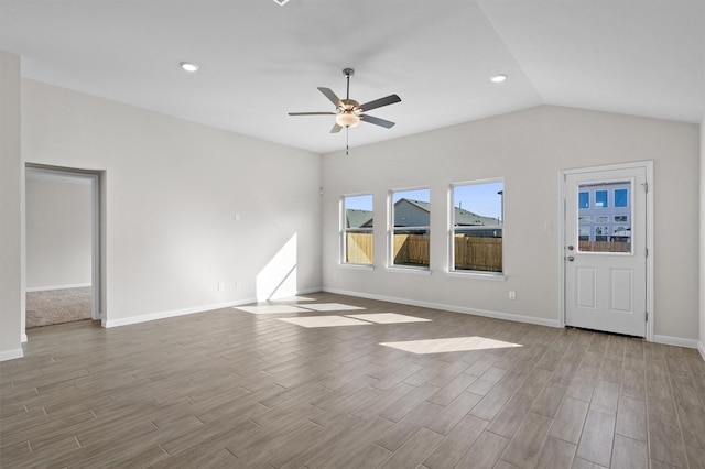 unfurnished living room featuring ceiling fan and lofted ceiling