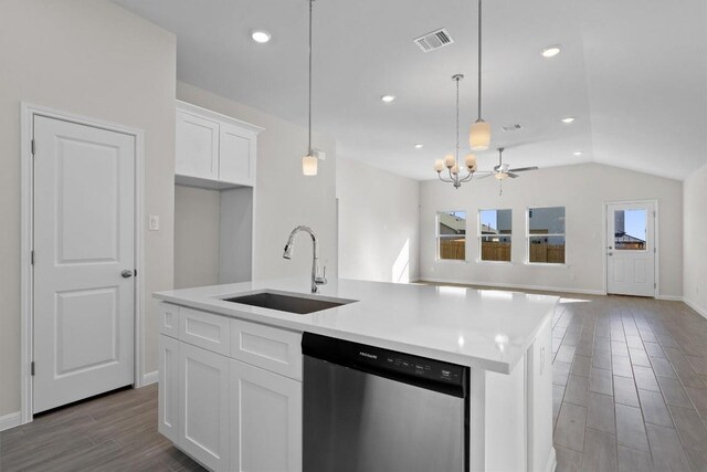 kitchen featuring visible vents, stainless steel dishwasher, a kitchen island with sink, a sink, and white cabinetry