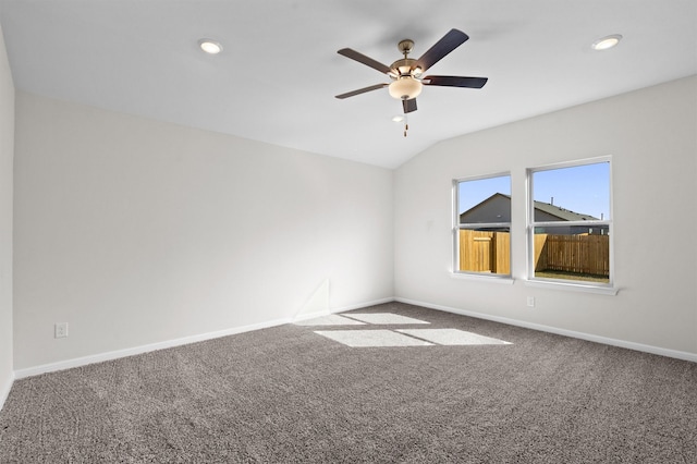 empty room with carpet flooring, ceiling fan, and lofted ceiling