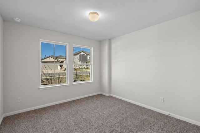 empty room with carpet floors and baseboards