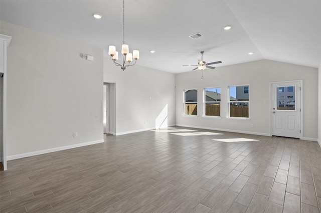 unfurnished living room with ceiling fan with notable chandelier and lofted ceiling