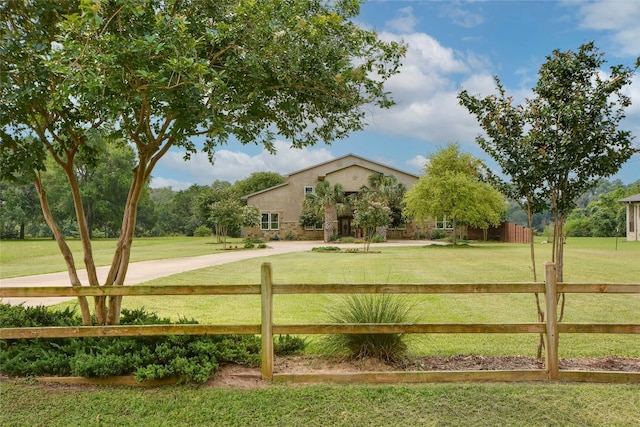 view of home's community featuring a lawn