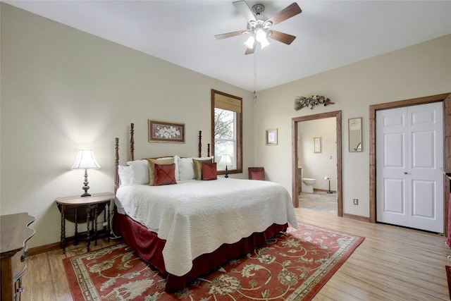 bedroom with connected bathroom, light hardwood / wood-style floors, and ceiling fan