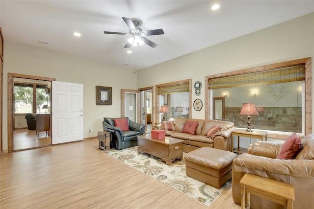 living room featuring ceiling fan and light hardwood / wood-style floors