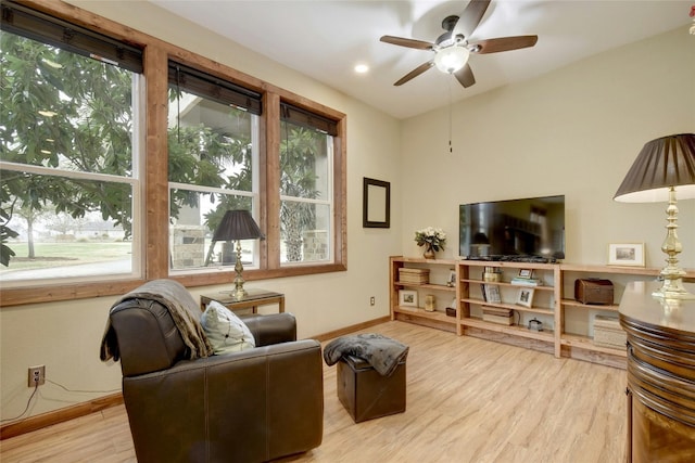 living room featuring light hardwood / wood-style flooring and ceiling fan