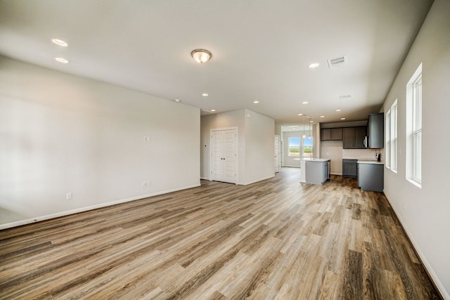 unfurnished living room with light hardwood / wood-style floors