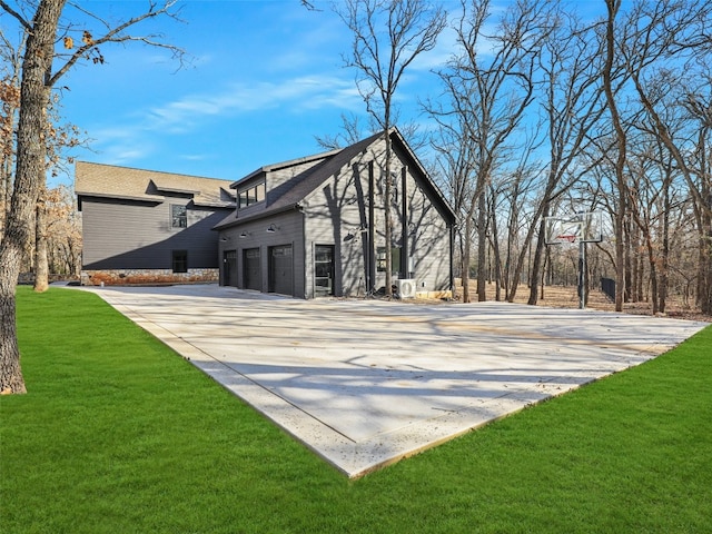 view of home's exterior featuring a garage and a lawn