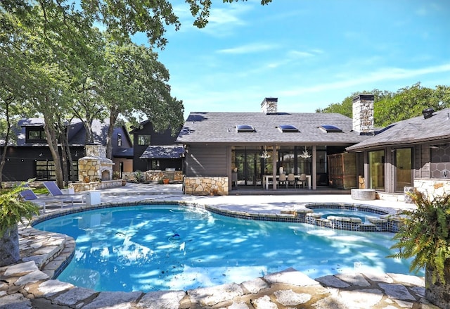 view of pool featuring a patio area, an in ground hot tub, and an outdoor stone fireplace