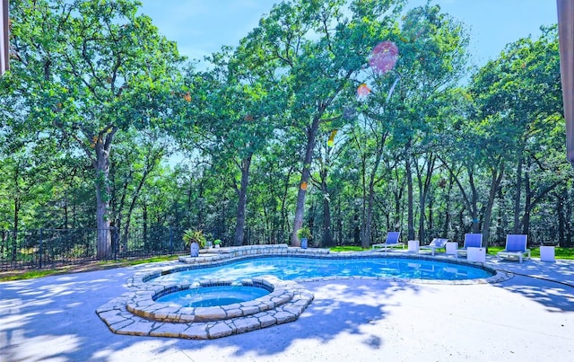 view of pool featuring an in ground hot tub and a patio area