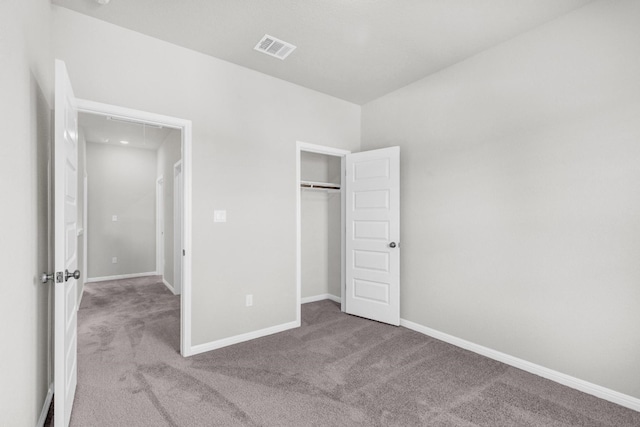 unfurnished bedroom featuring carpet and a closet