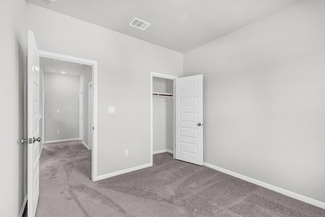 unfurnished bedroom with a closet and carpet flooring