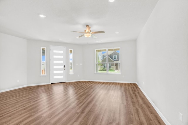 unfurnished room with wood-type flooring and ceiling fan