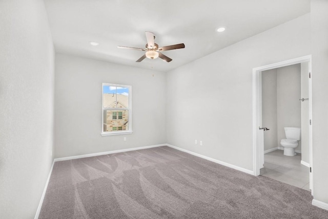 unfurnished bedroom with light carpet, ensuite bath, and ceiling fan