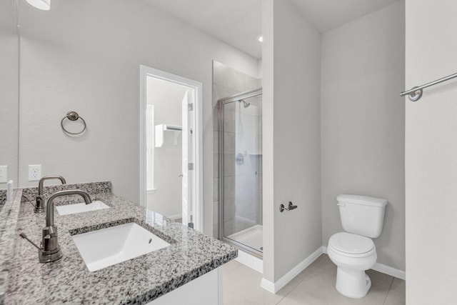 bathroom featuring a shower with shower door, toilet, tile patterned flooring, and dual bowl vanity