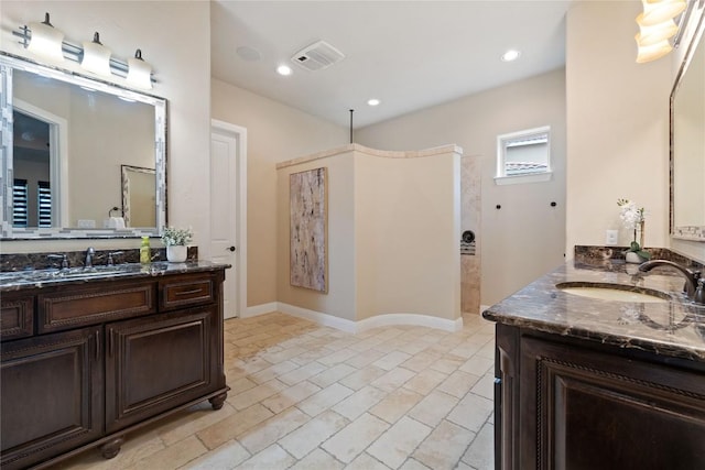 bathroom featuring a shower and vanity