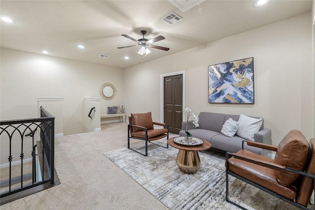 carpeted living room with ceiling fan