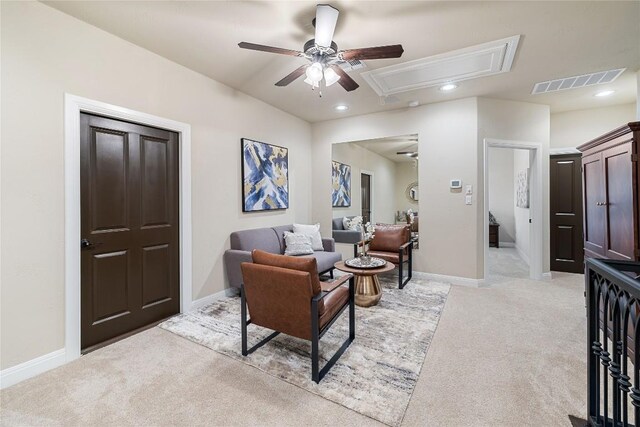 living room with light colored carpet, ceiling fan, visible vents, attic access, and recessed lighting